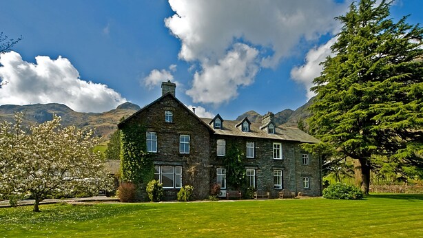 A stone house with multiple windows and a large lawn. - New Dungeon Ghyll Hotel (Ambleside)