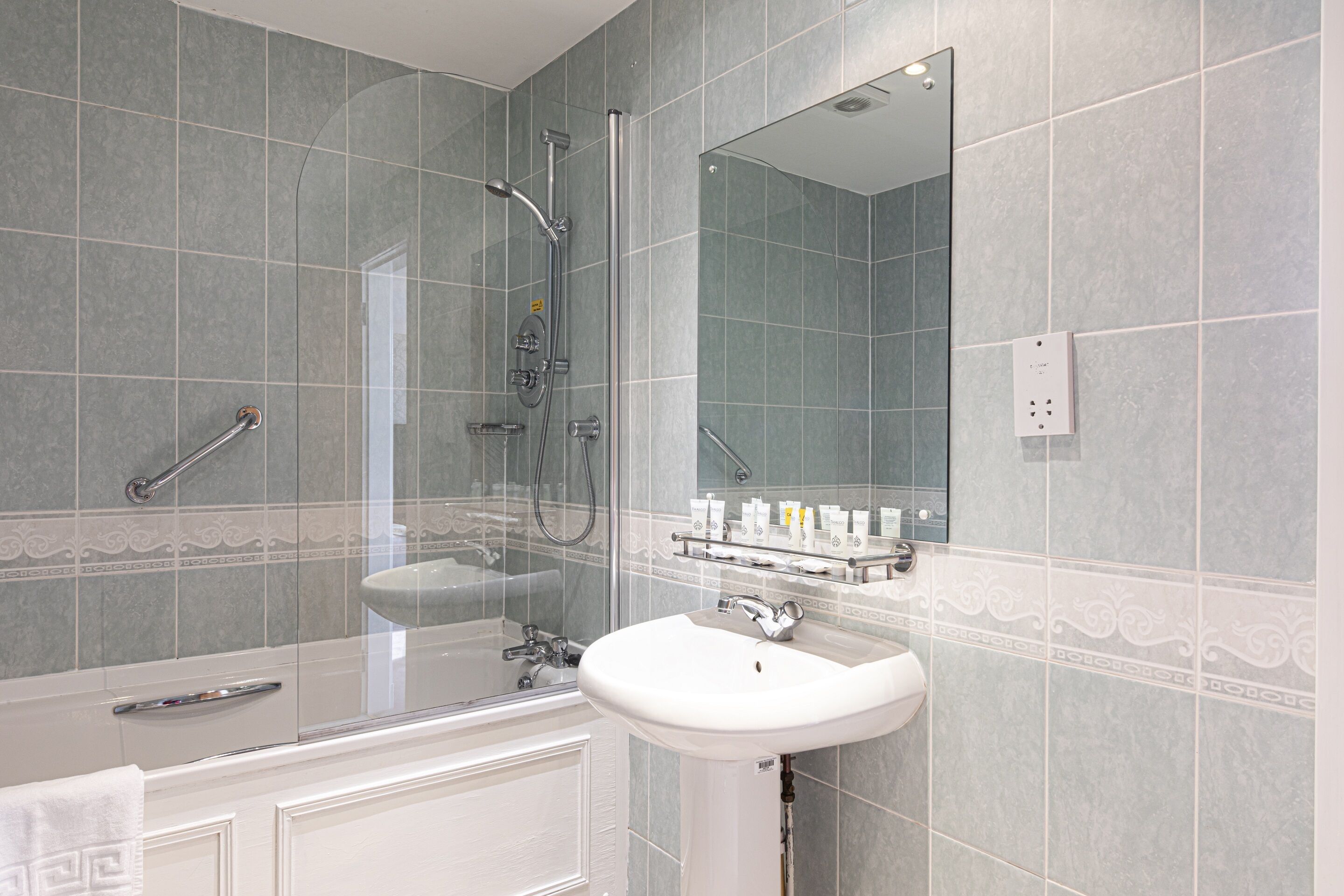A bathroom with a bathtub, a sink, and a shower.