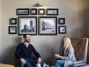 Relax in a serene space with a large framed photograph and a cozy seating area.
