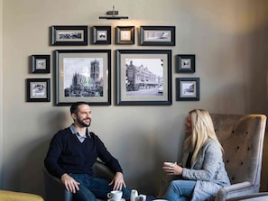 Relax in a serene space with a large framed photograph and a cozy seating area.