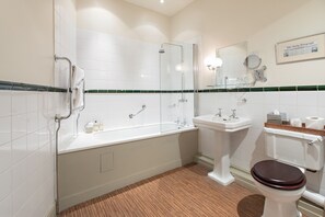 A modern bathroom with a bathtub, a sink, and a toilet.
