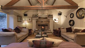 A cozy living room with two sofas, a fireplace, and a coffee table. - The White Swan Inn (Pickering)