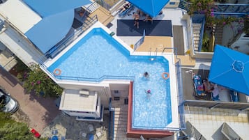 Relax by the rooftop pool, surrounded by a covered deck and outdoor seating area.