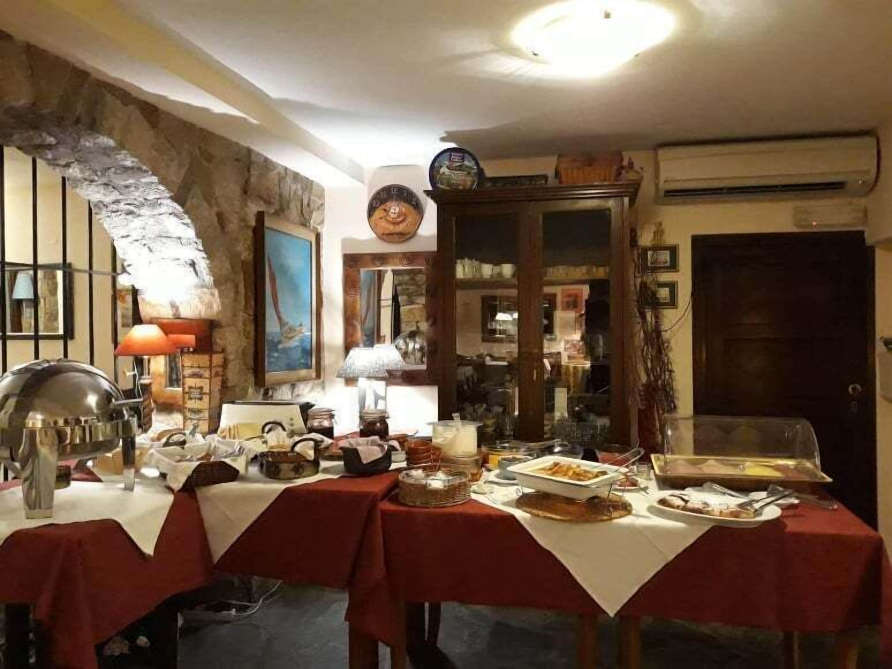 Un espace repas agrémenté d’un mur en pierre, d’un tableau et d’un buffet.