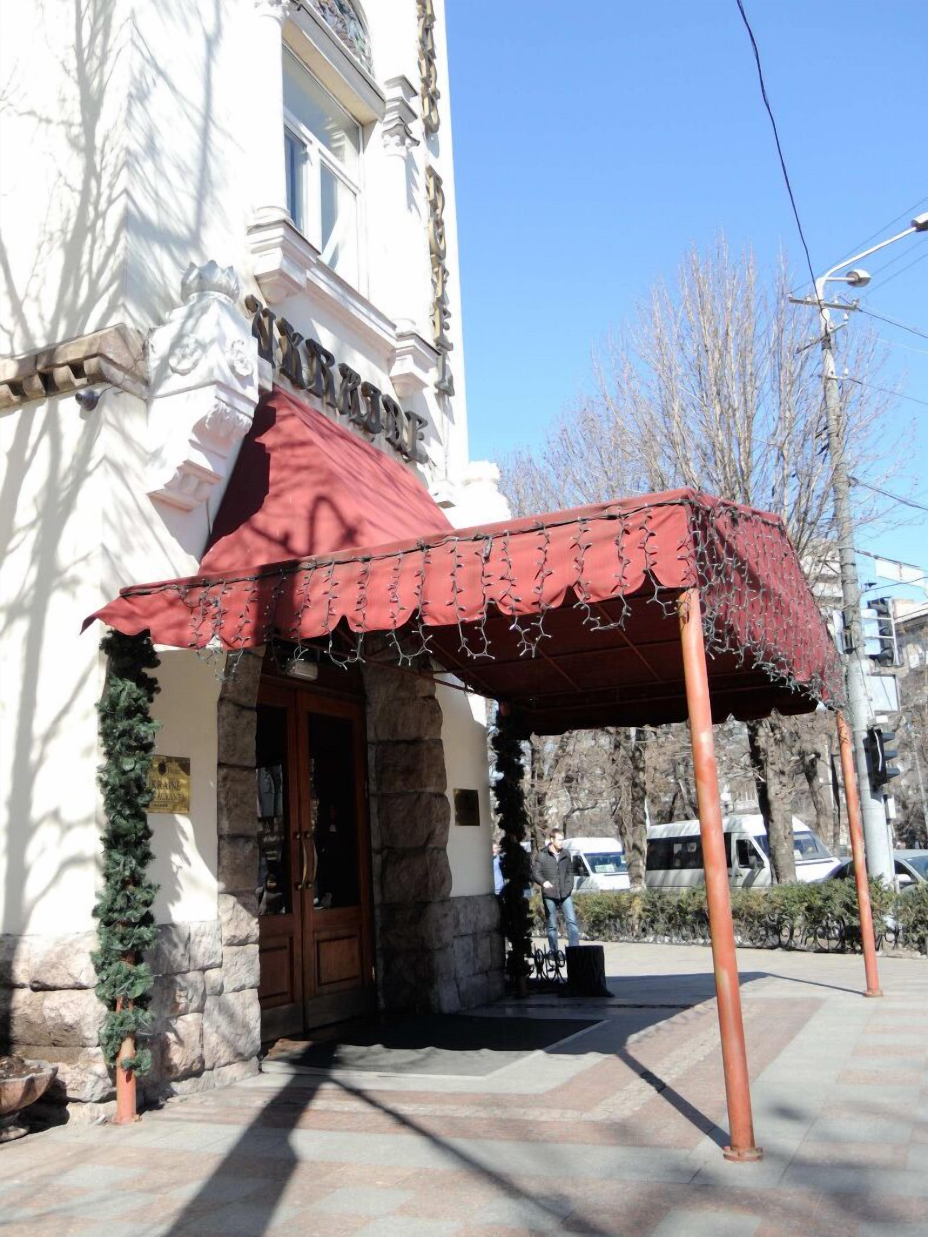 A building with a stone facade, a red awning, and a sign that reads "Hôtel de Ville".