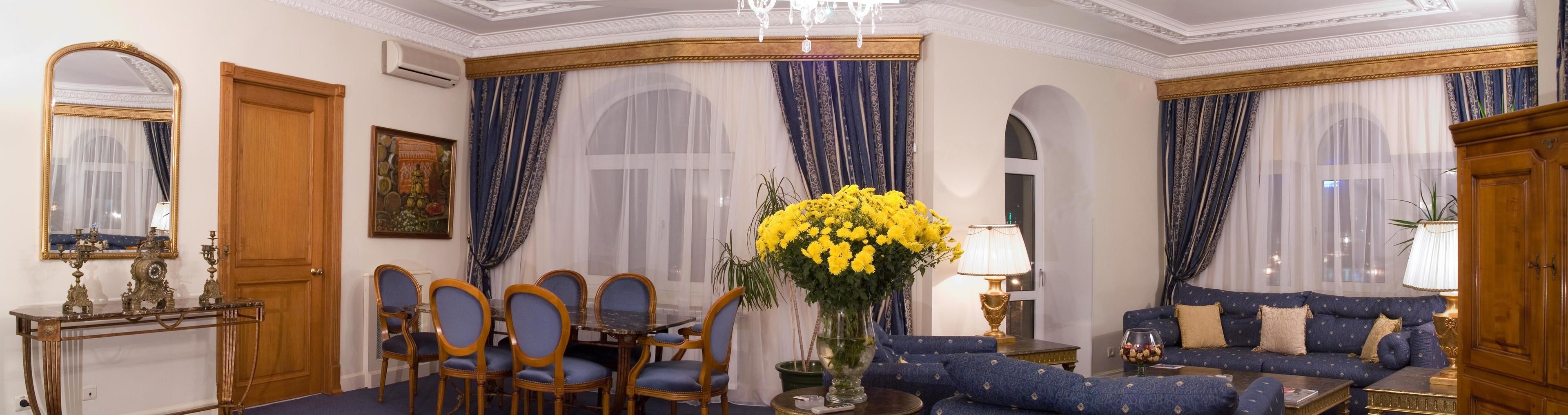 Una habitación con comedor, sofá y candelabro.