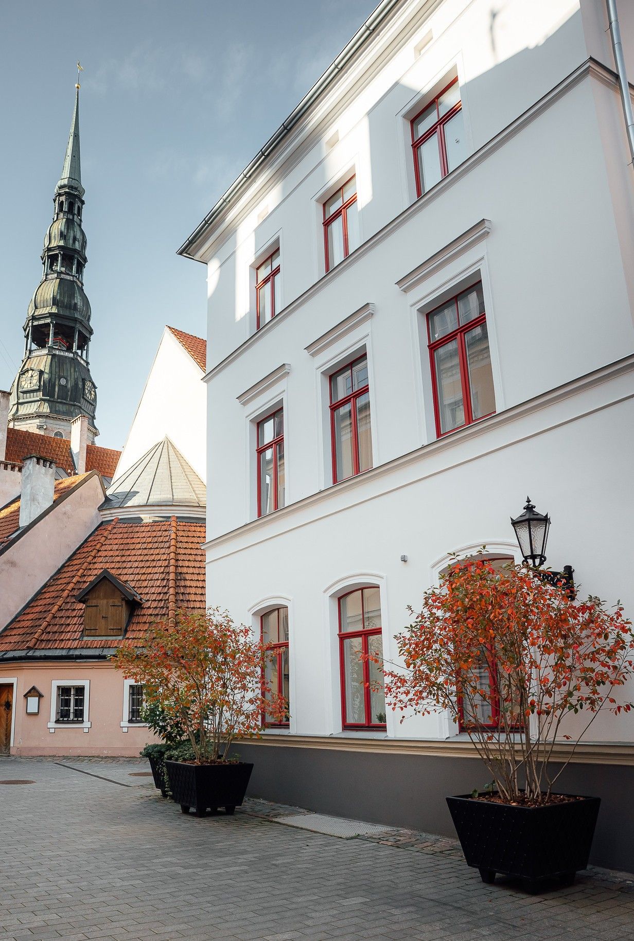 A building with multiple windows and a traditional spire.