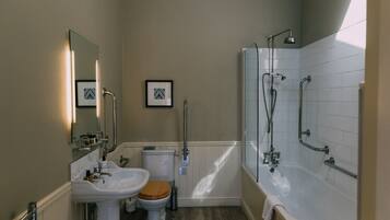 A bathroom with a sink, toilet, and bathtub.