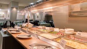 A buffet area with various food options, including rice, vegetables, and meats. - Premier Hotel Dnister (Lviv)