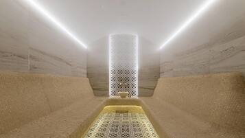 Relax in a serene spa room with a central column featuring a patterned design, minimalist aesthetic, and two cushioned seating areas.
