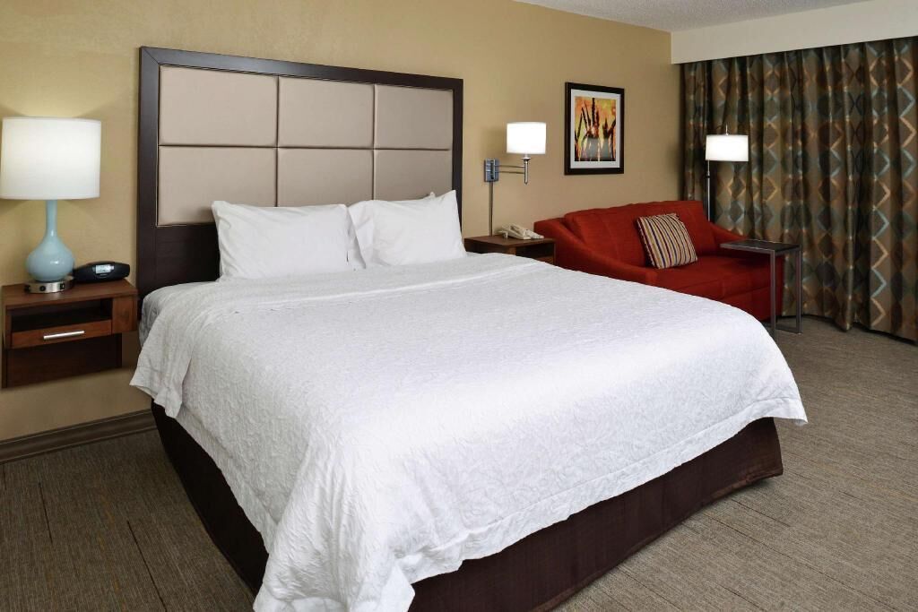 Premium bedding, desk, laptop workspace, blackout drapes
