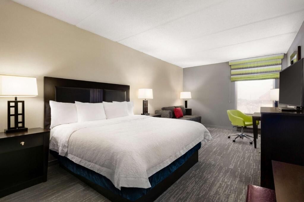 Premium bedding, desk, laptop workspace, blackout drapes