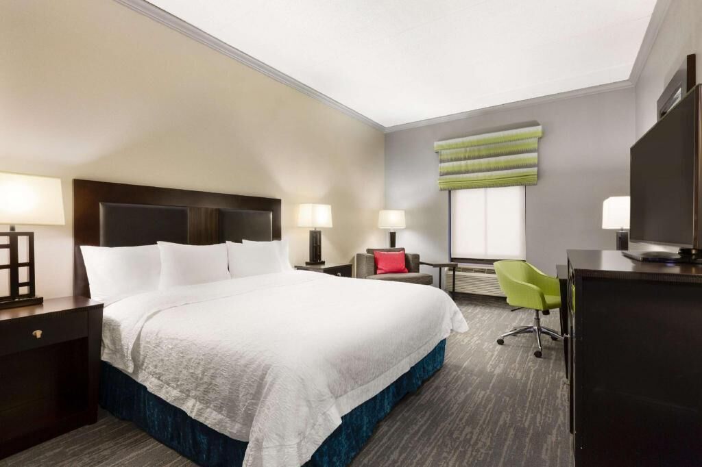 Premium bedding, desk, laptop workspace, blackout drapes