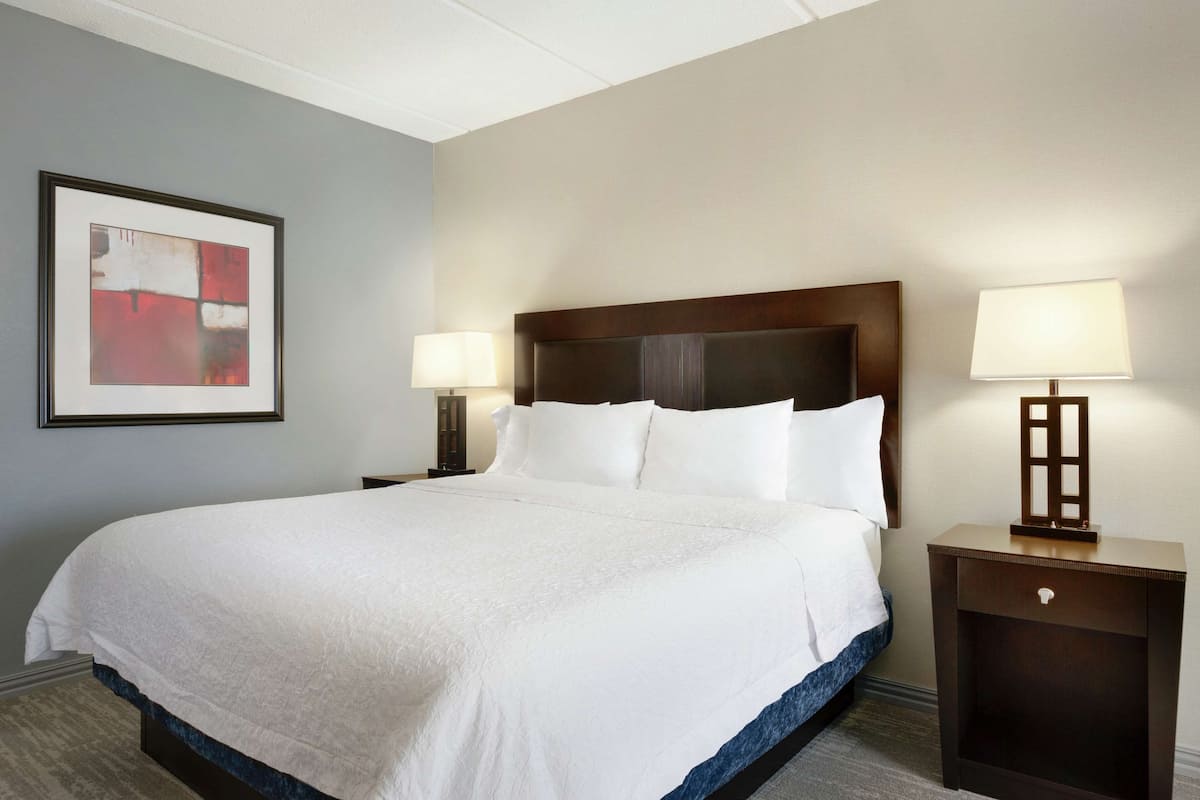 Premium bedding, desk, laptop workspace, blackout drapes