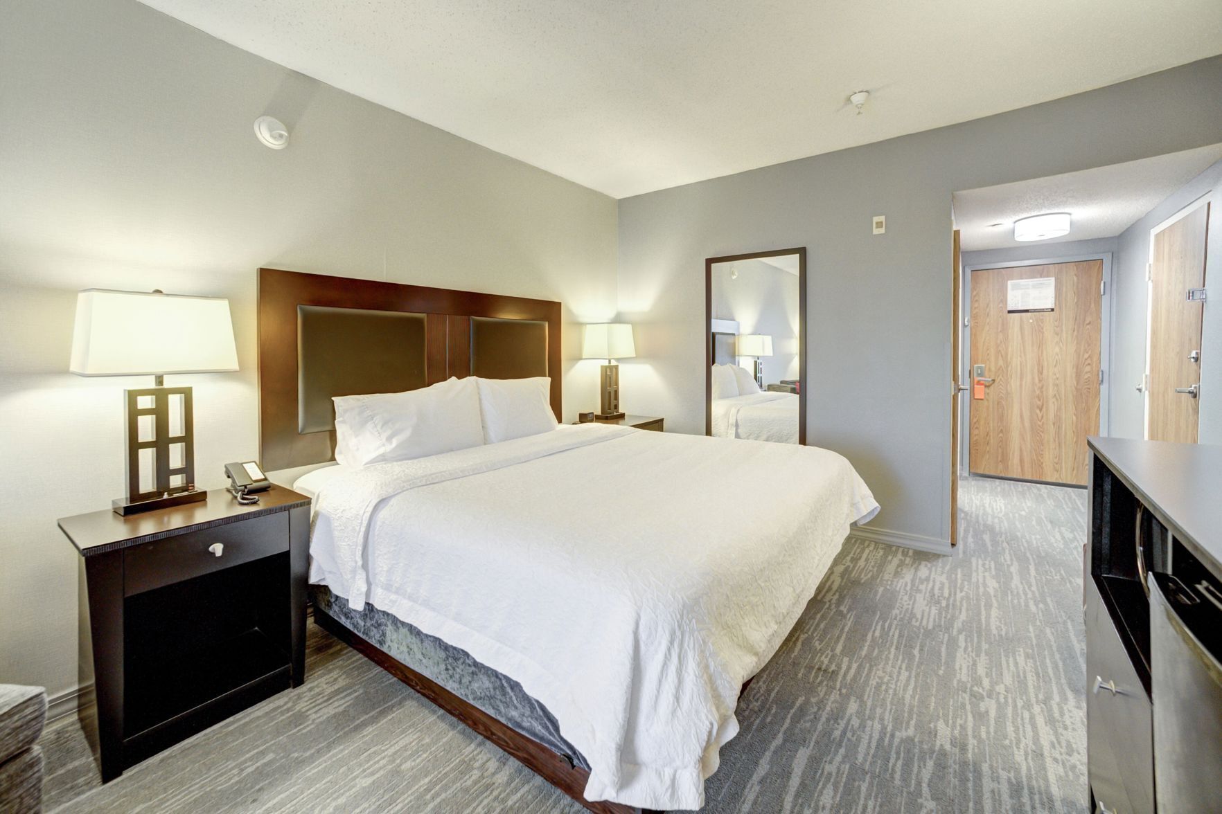 Premium bedding, desk, laptop workspace, blackout drapes