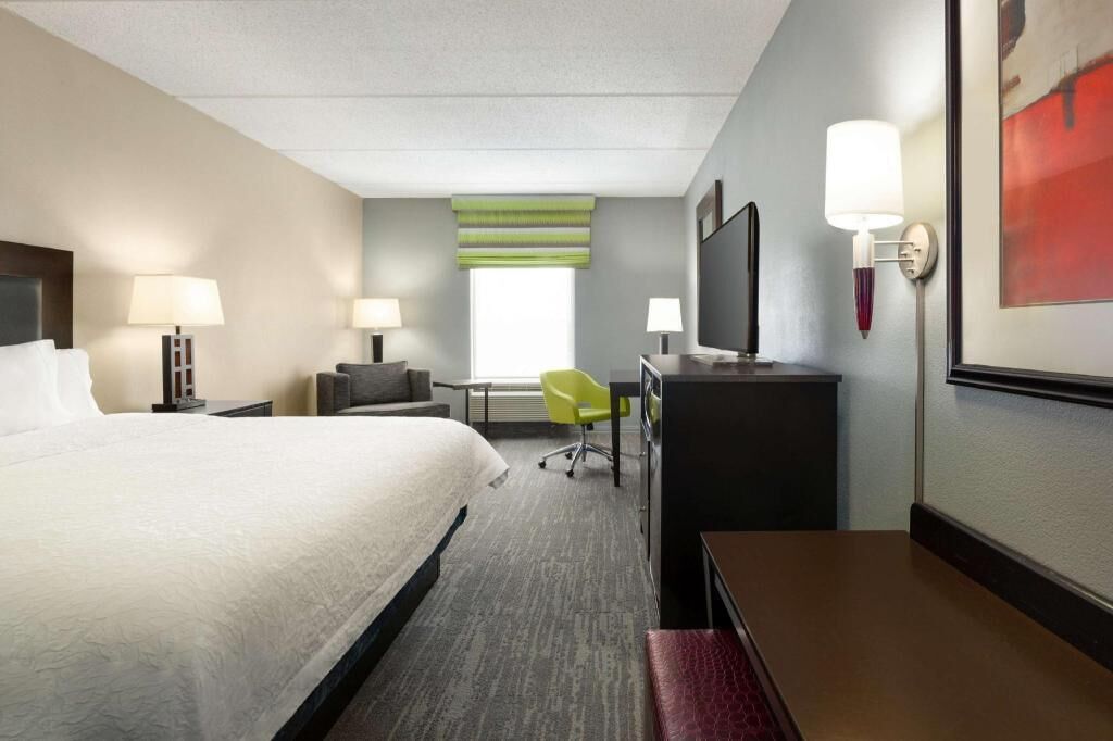 Premium bedding, desk, laptop workspace, blackout drapes
