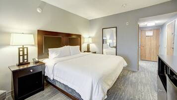 Premium bedding, desk, laptop workspace, blackout drapes