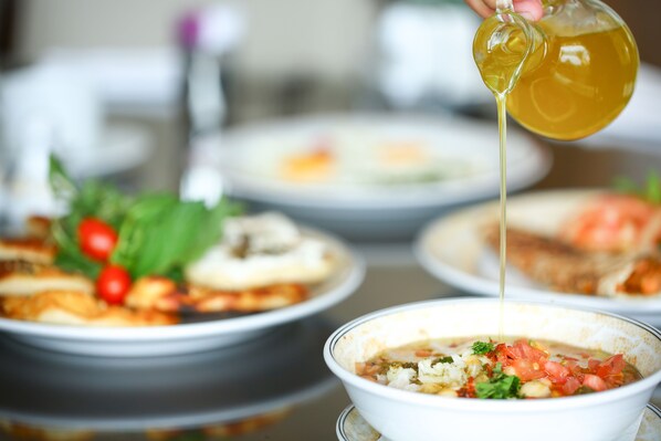 A bowl of soup with a clear liquid being poured into it. - InterContinental Phoenicia Beirut by IHG (Beirut)