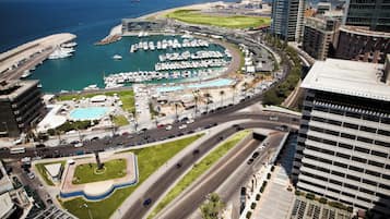 A marina with boats, a swimming pool, and a road with vehicles.