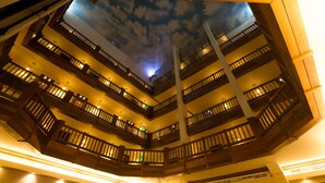 A multi-level atrium with wooden balconies and a ceiling mural of clouds. - InterContinental Mzaar Lebanon by IHG (Mzaar Kfardebian)