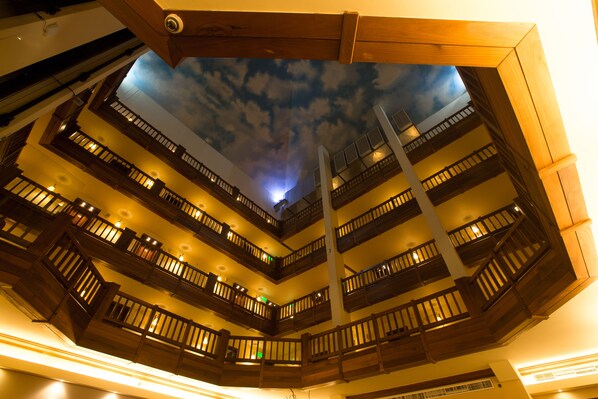 A multi-level atrium with wooden balconies and a ceiling mural of clouds. - InterContinental Mzaar Lebanon by IHG (Mzaar Kfardebian)