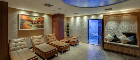 A modern spa room with leather seating, a mural, and a textured wall.