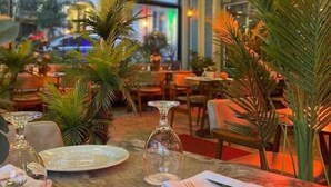 A restaurant interior with tables set for dining, featuring potted plants and a modern ceiling design. - Blue House Hotel (Istanbul)