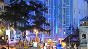 A multi-story building with a distinctive blue and white facade, large windows, and a rooftop terrace. - Blue House Hotel (Istanbul)