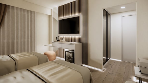 Una habitación de hotel moderna con dos camas, una televisión de pantalla plana, un minibar y una puerta que da a otra habitación.