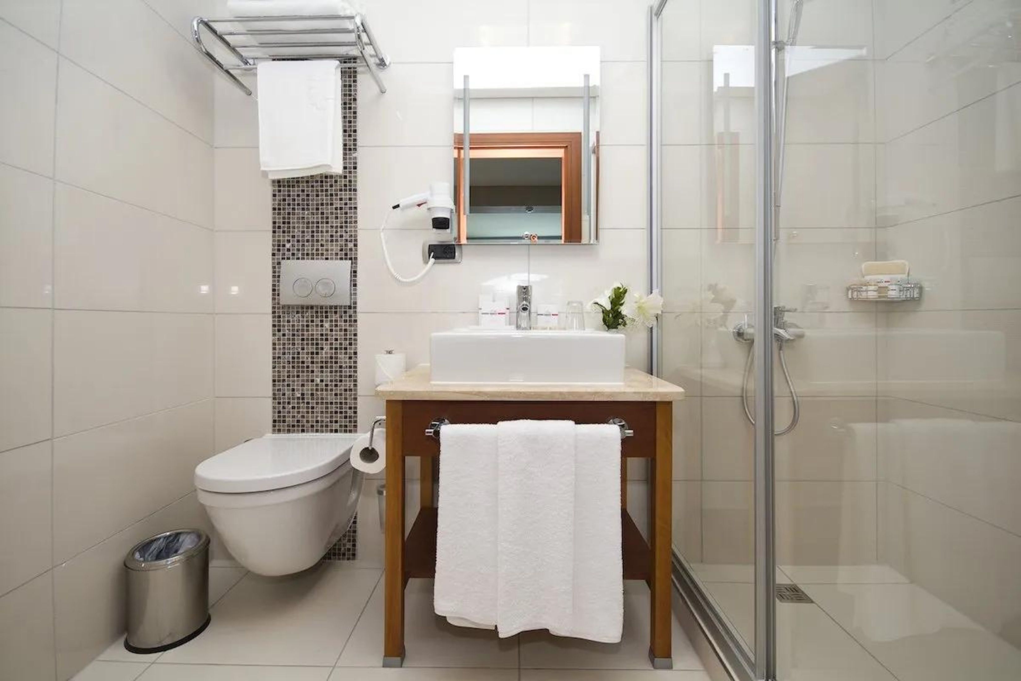 Ein modernes Badezimmer mit Toilette, Waschbecken und Dusche.