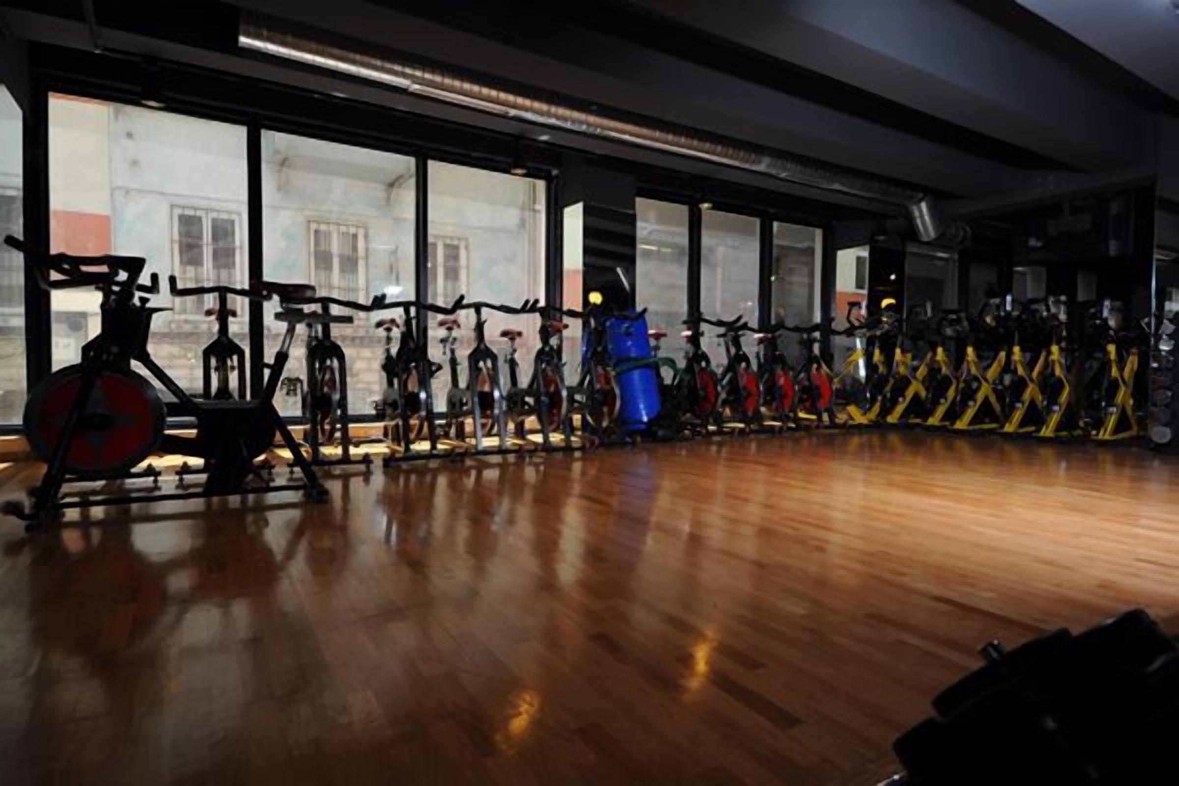 A gym with stationary bikes and exercise equipment.