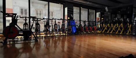 A gym with stationary bikes and exercise equipment.