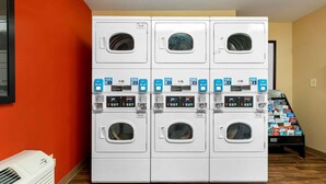 A laundry facility with six stacked washing machines, each with a digital display and control panel. - Extended Stay America Suites Chicago Skokie (Skokie)