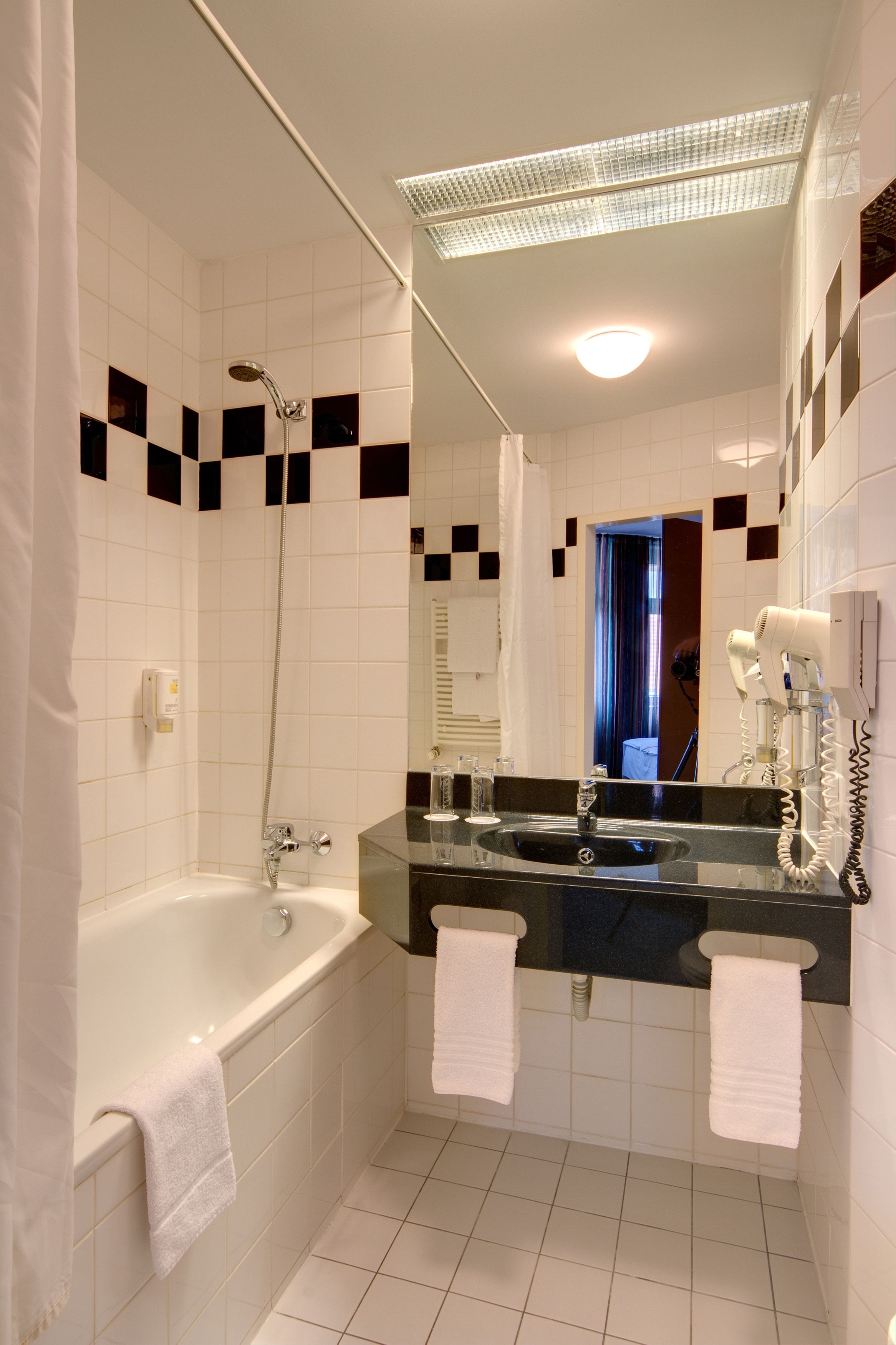 designer toiletries, hair dryer, towels