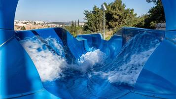 Experience the thrill of a smooth, curved water slide with breathtaking views of the surrounding landscape.