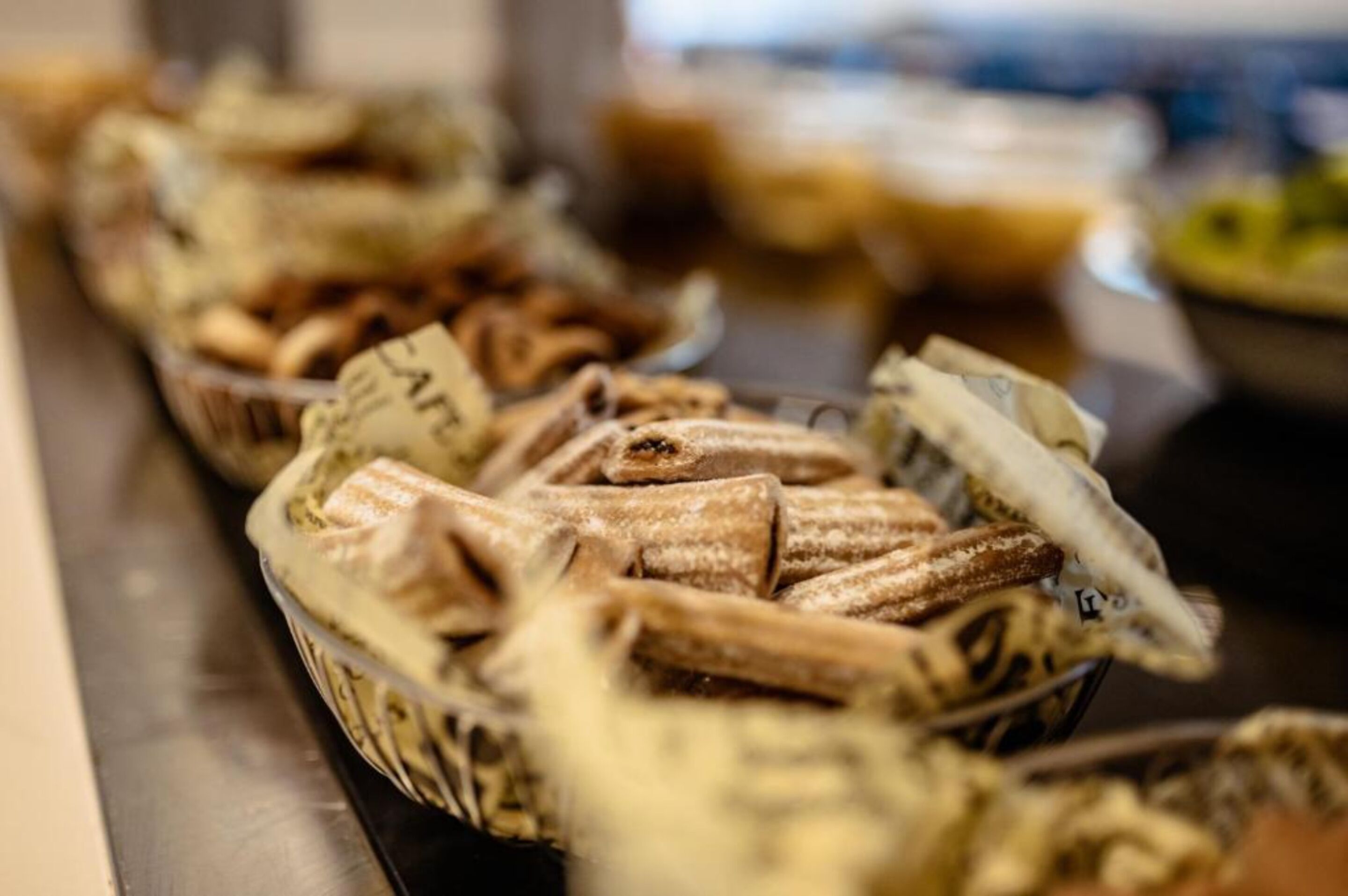 A buffet table with various food items, including pastries and desserts.
