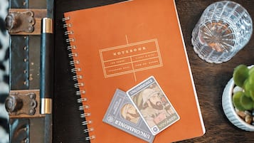 A notebook on a wooden tray with a metal clasp.