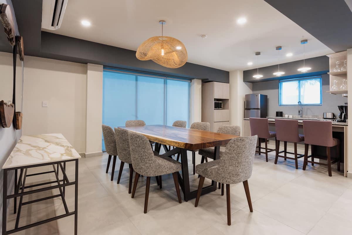 A modern kitchen with a dining area.