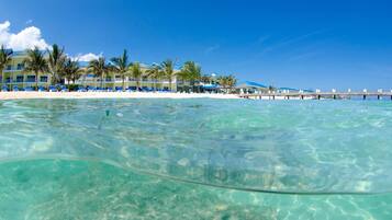 On the beach, white sand, sun loungers, beach towels