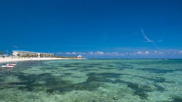 On the beach, white sand, sun loungers, beach towels