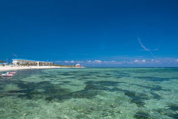 On the beach, white sand, sun-loungers, beach towels