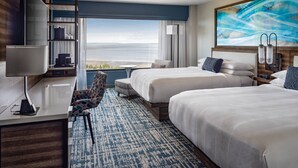 A hotel room with two beds, a desk with a chair, a TV, and a large window with a view. - Marriott Anchorage Downtown (Anchorage)