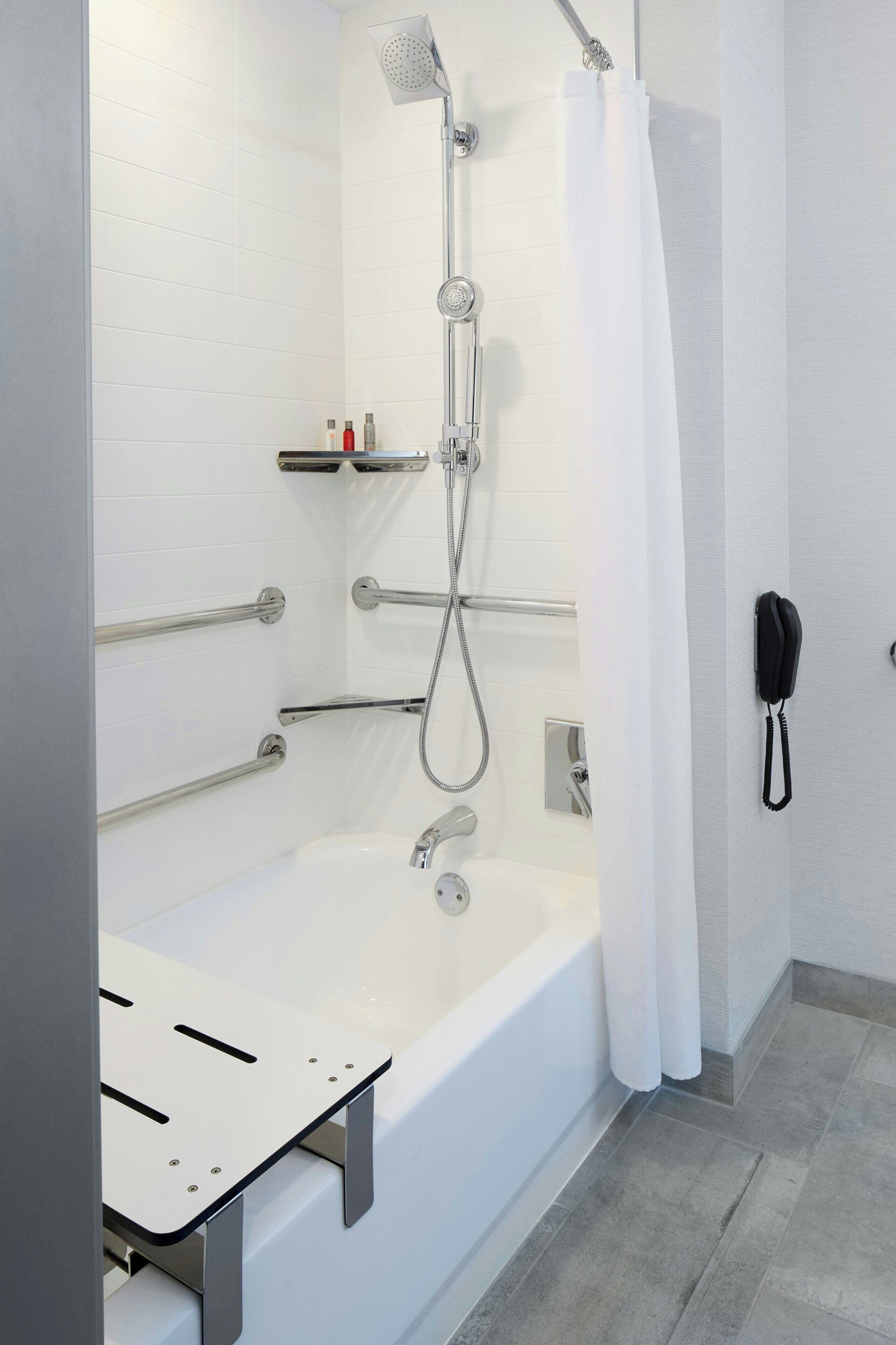 combined shower/bathtub, designer toiletries, hair dryer, towels