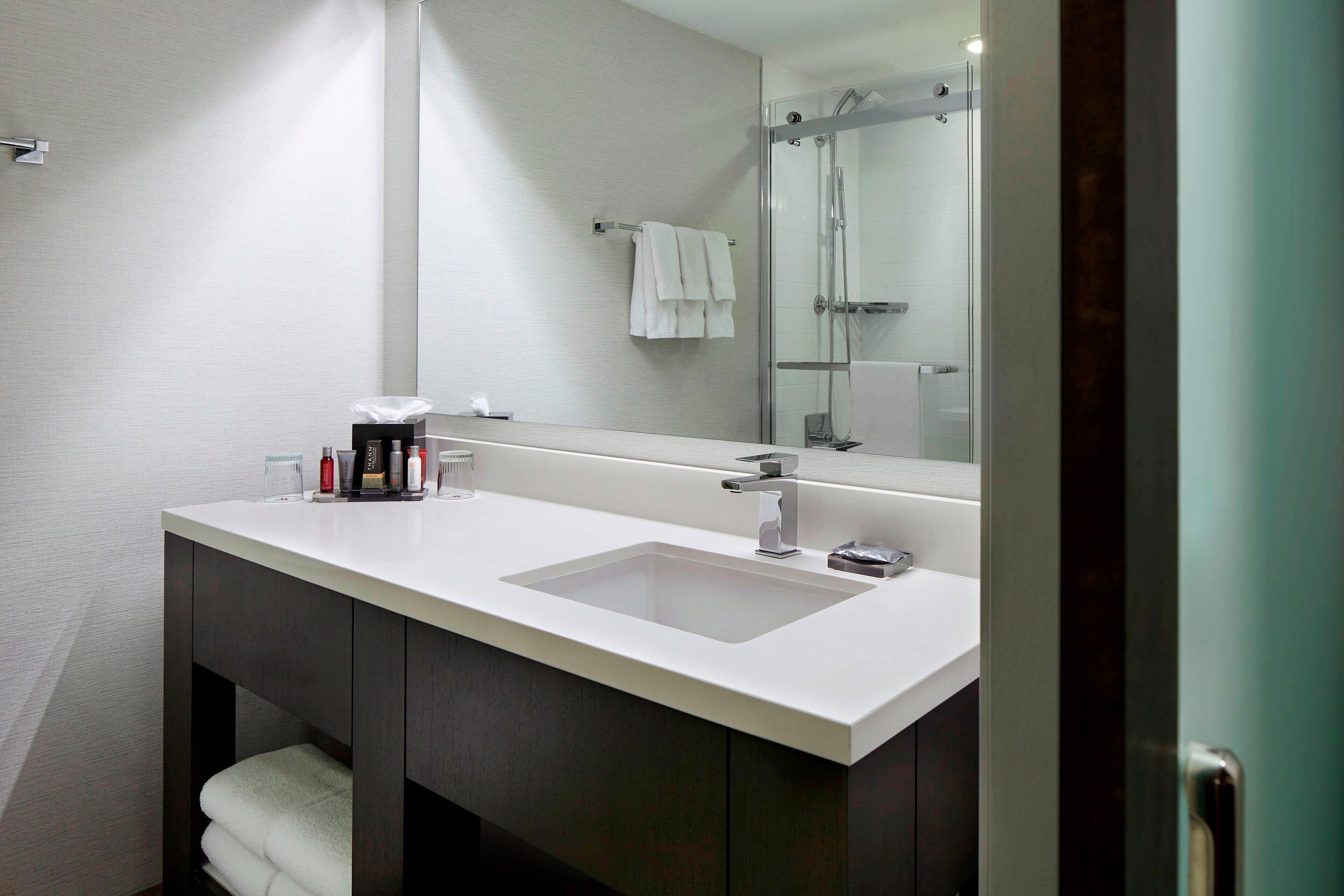 combined shower/bathtub, designer toiletries, hair dryer, towels