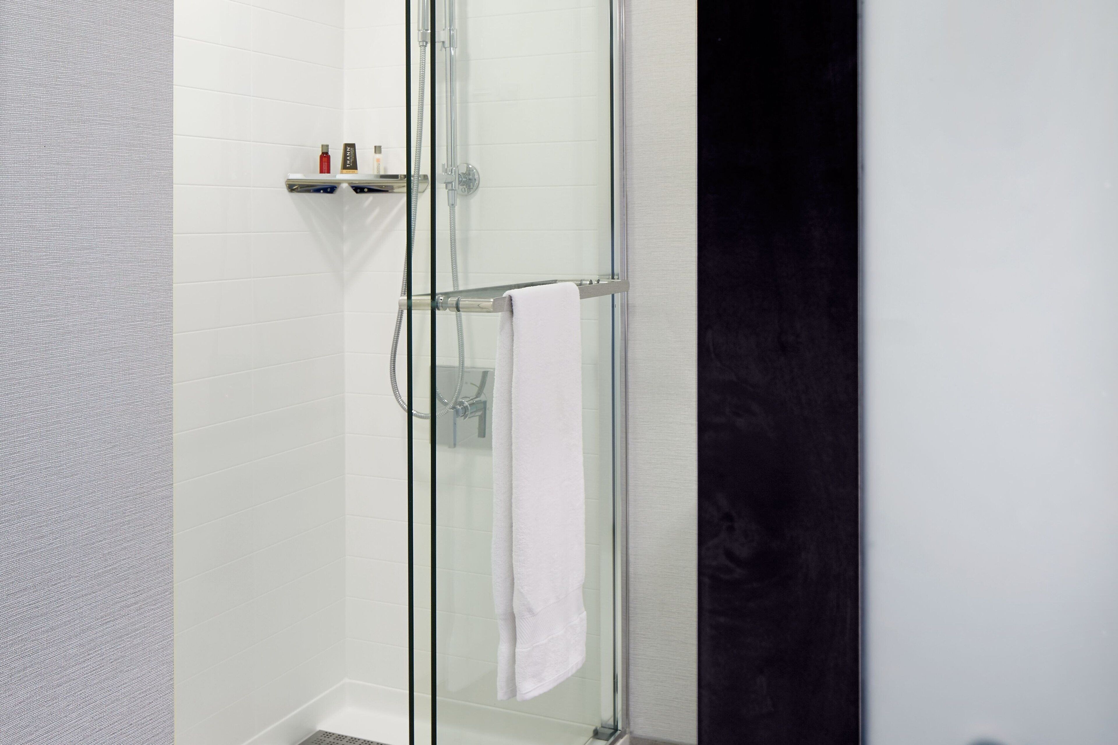 combined shower/bathtub, designer toiletries, hair dryer, towels
