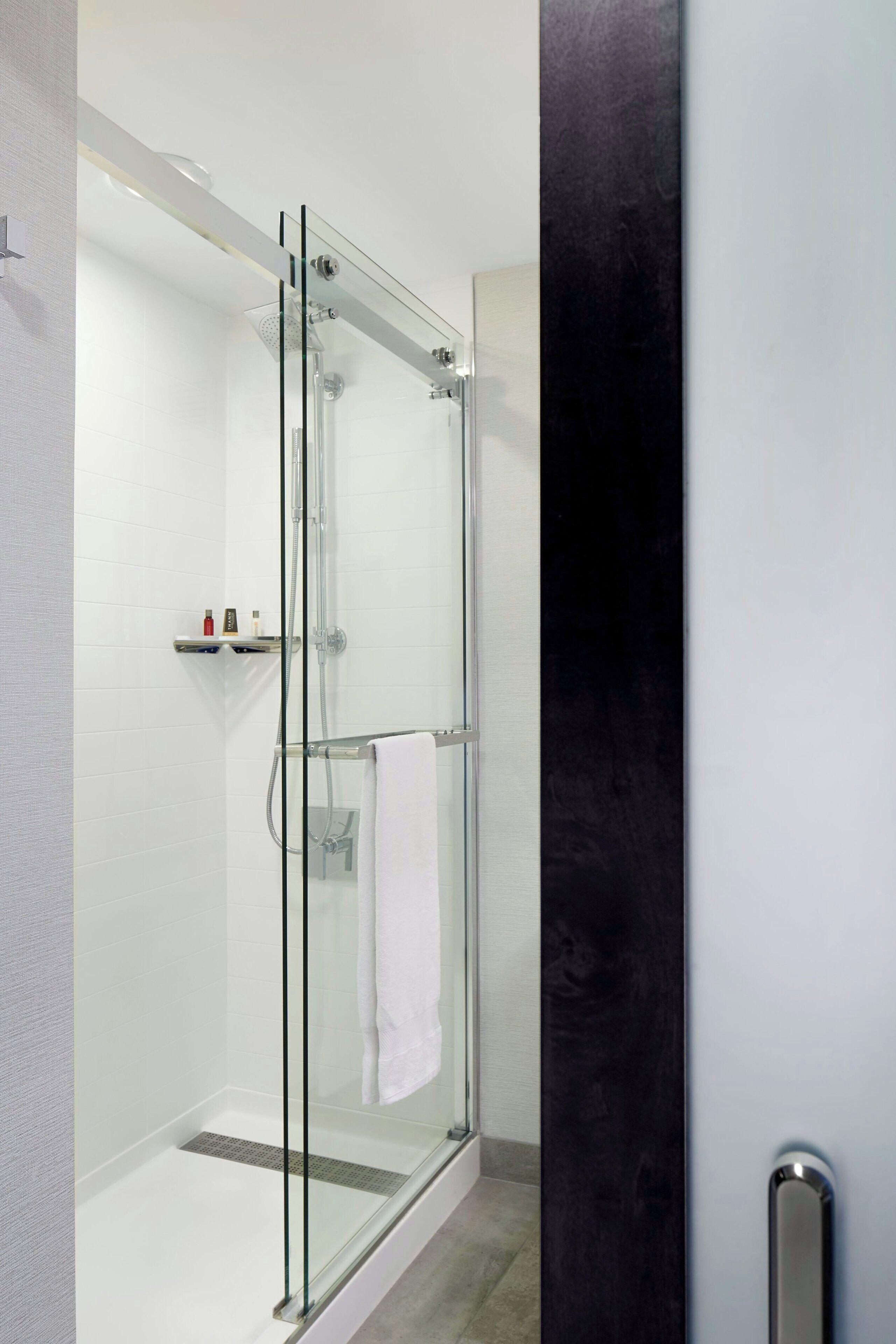 combined shower/bathtub, designer toiletries, hair dryer, towels