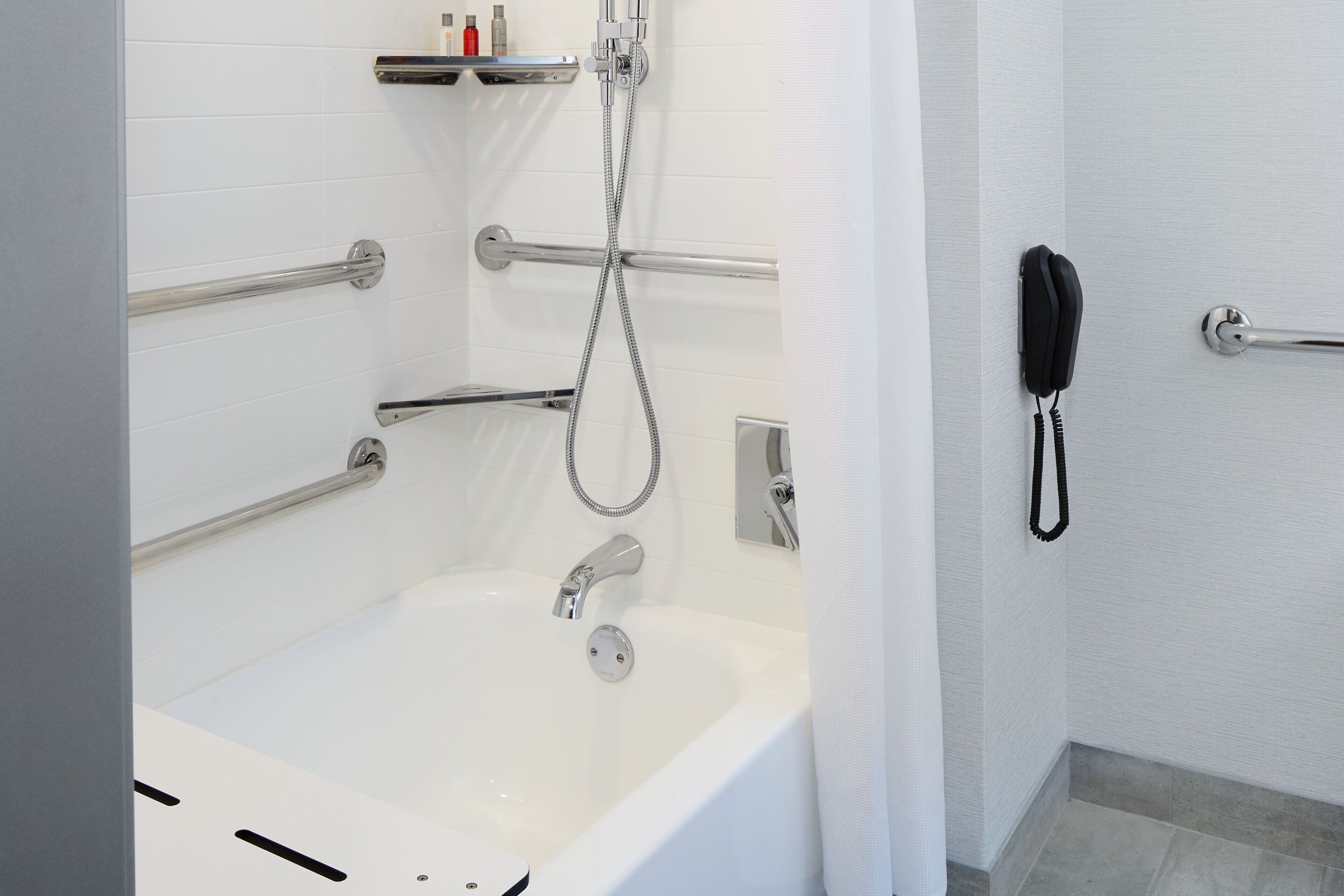 combined shower/bathtub, designer toiletries, hair dryer, towels