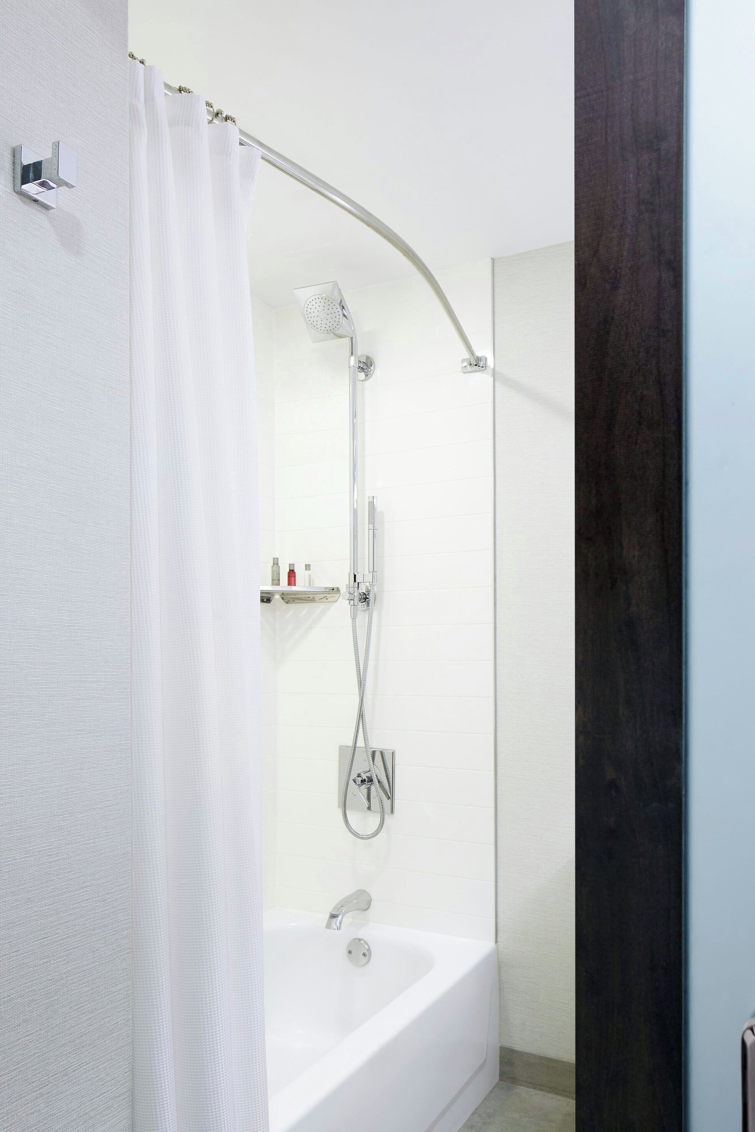 combined shower/bathtub, designer toiletries, hair dryer, towels