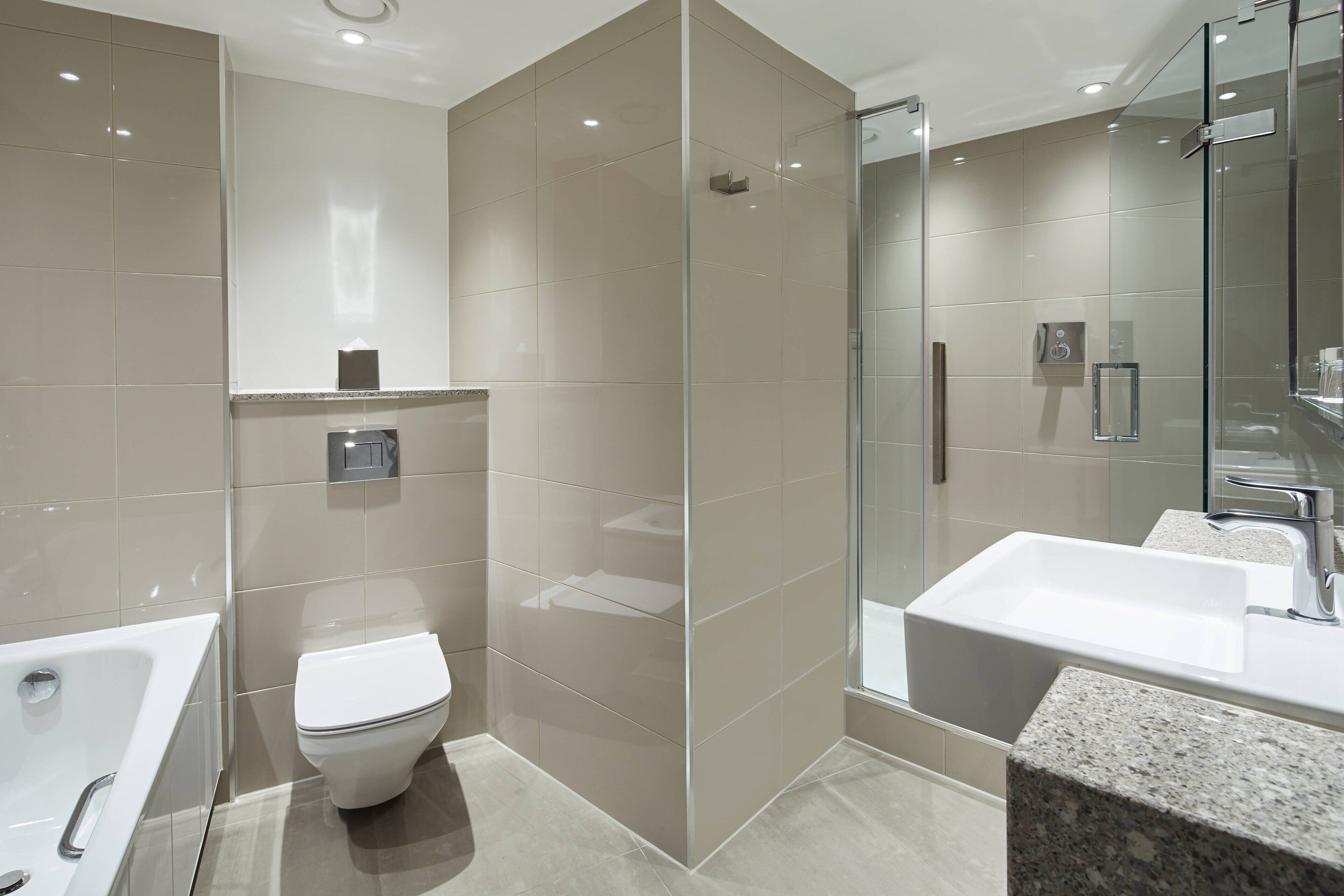 combined shower/bathtub, designer toiletries, hair dryer, towels