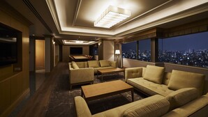 A spacious, elegantly furnished lounge with a city view, featuring sofas, a coffee table, and a television. - Tobu Hotel Levant Tokyo (Tokyo)
